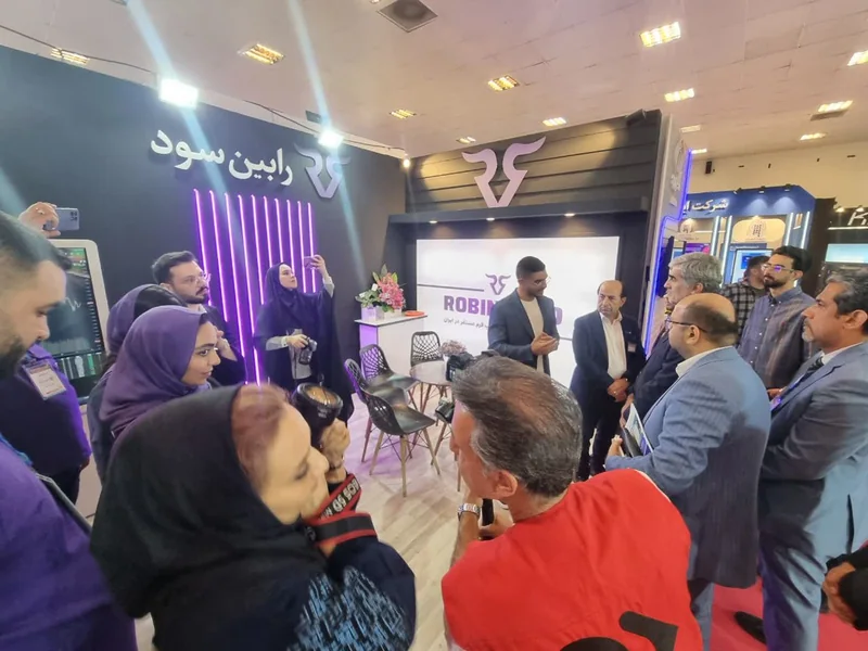 غرفه شلوغ رابینسود با لوگوی برند و بازدیدکنندگان در یازدهمین نمایشگاه تراکنش ایران